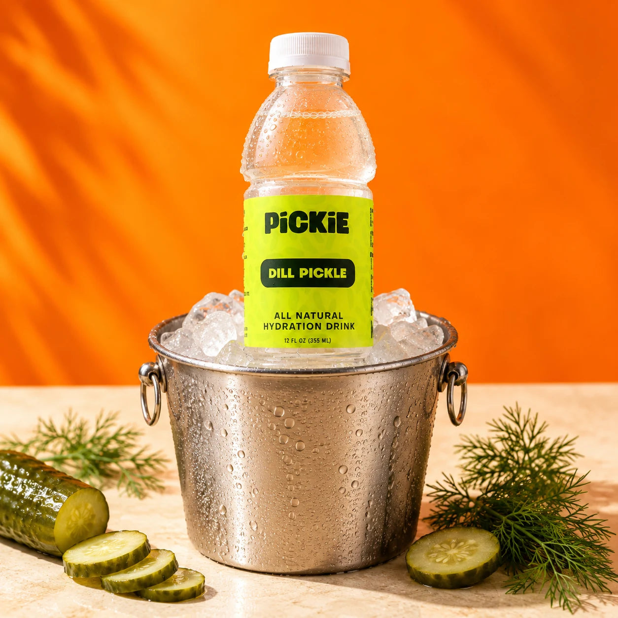 PiCKiE chilled in a silver ice bucket with dill and pickle slices