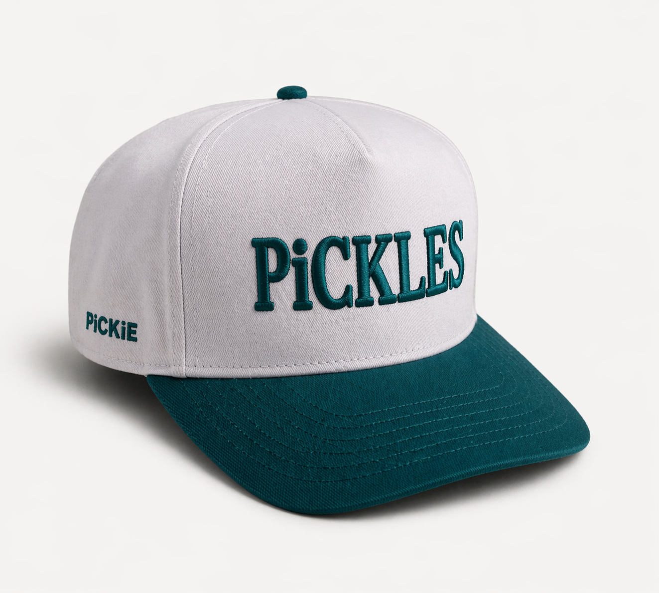 White and teal cap with 'PiCKLES' text on a white background