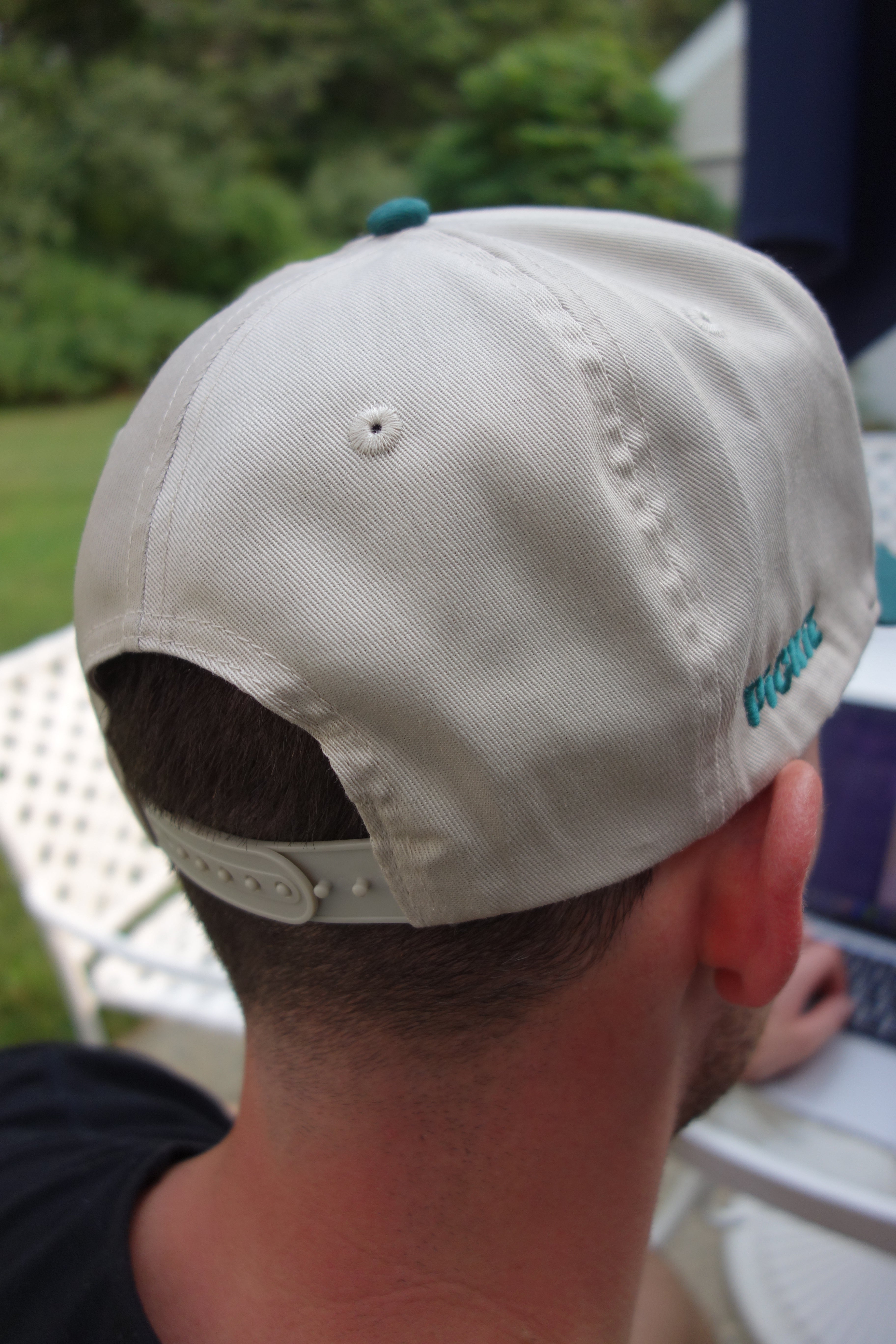 Beige cap worn by a person with a blurred background