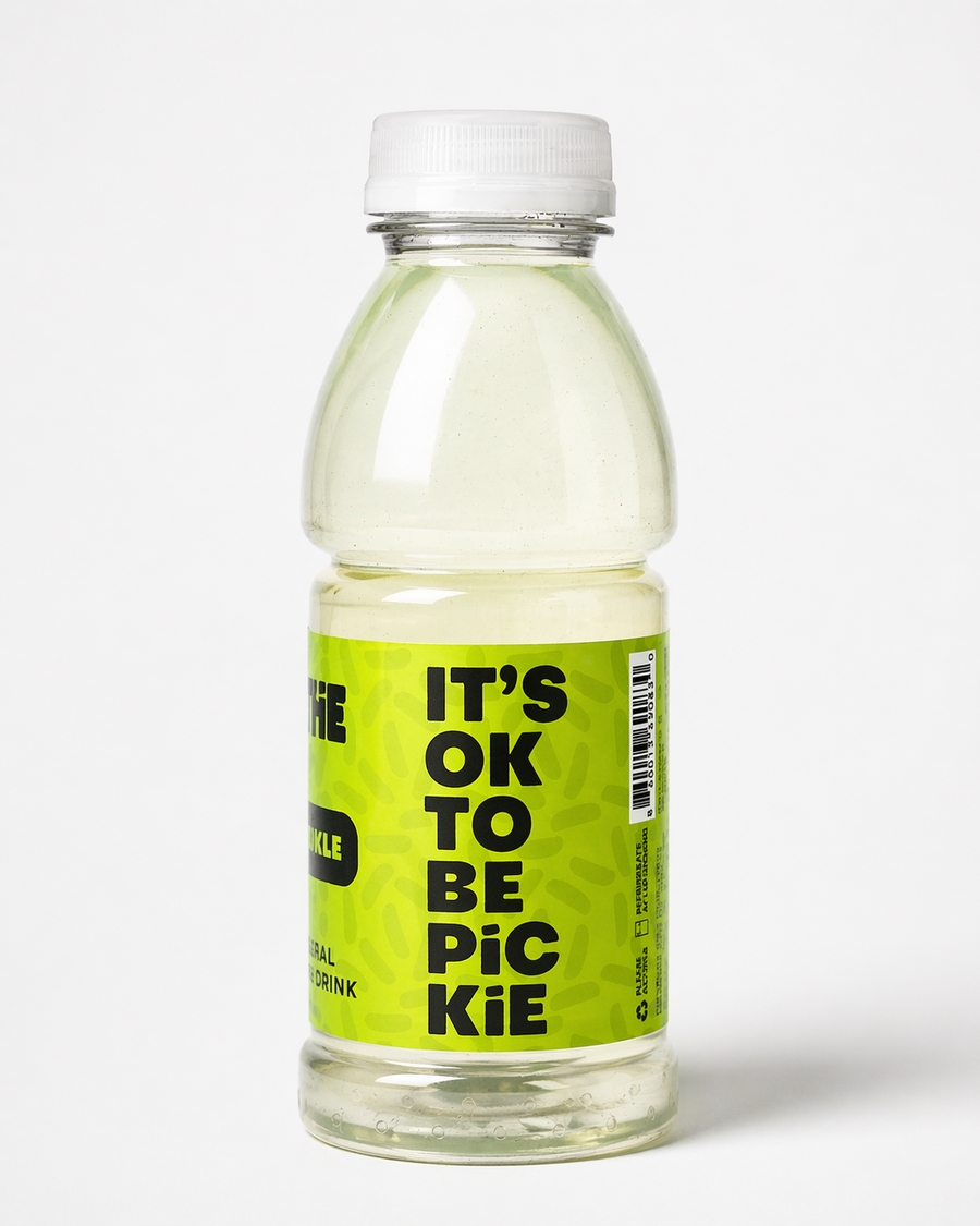 Bottle of 'It's Ok to Be Picie' drink with a green label on a white background